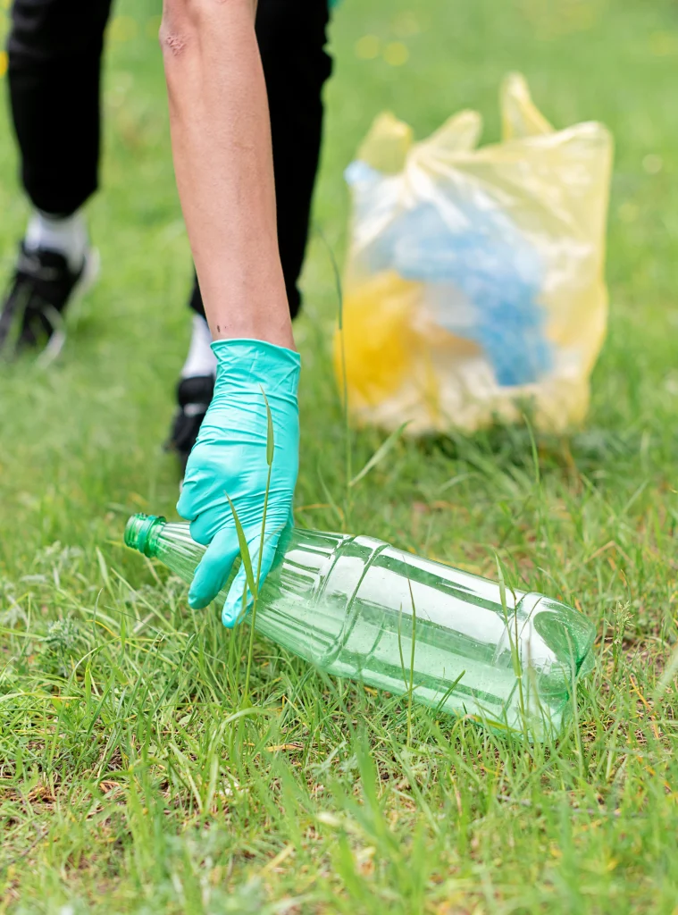 Hand picking up plastic bottle
